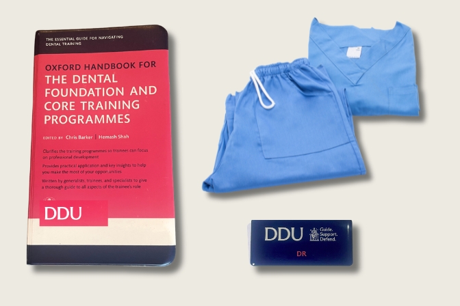 image of scrubs, badge and oxford press book
