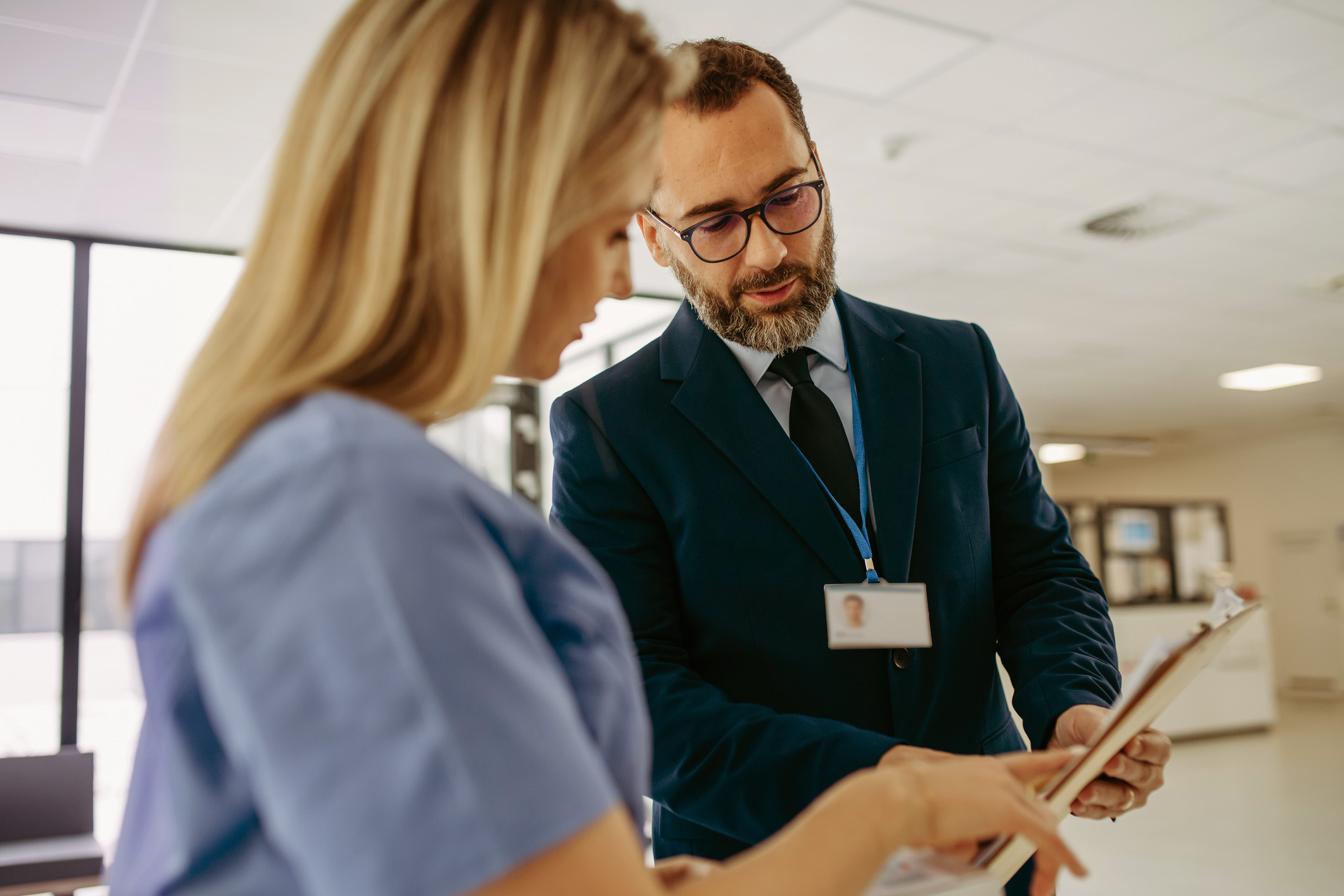 GP talking to healthcare professional staff whilst looking at paperwork