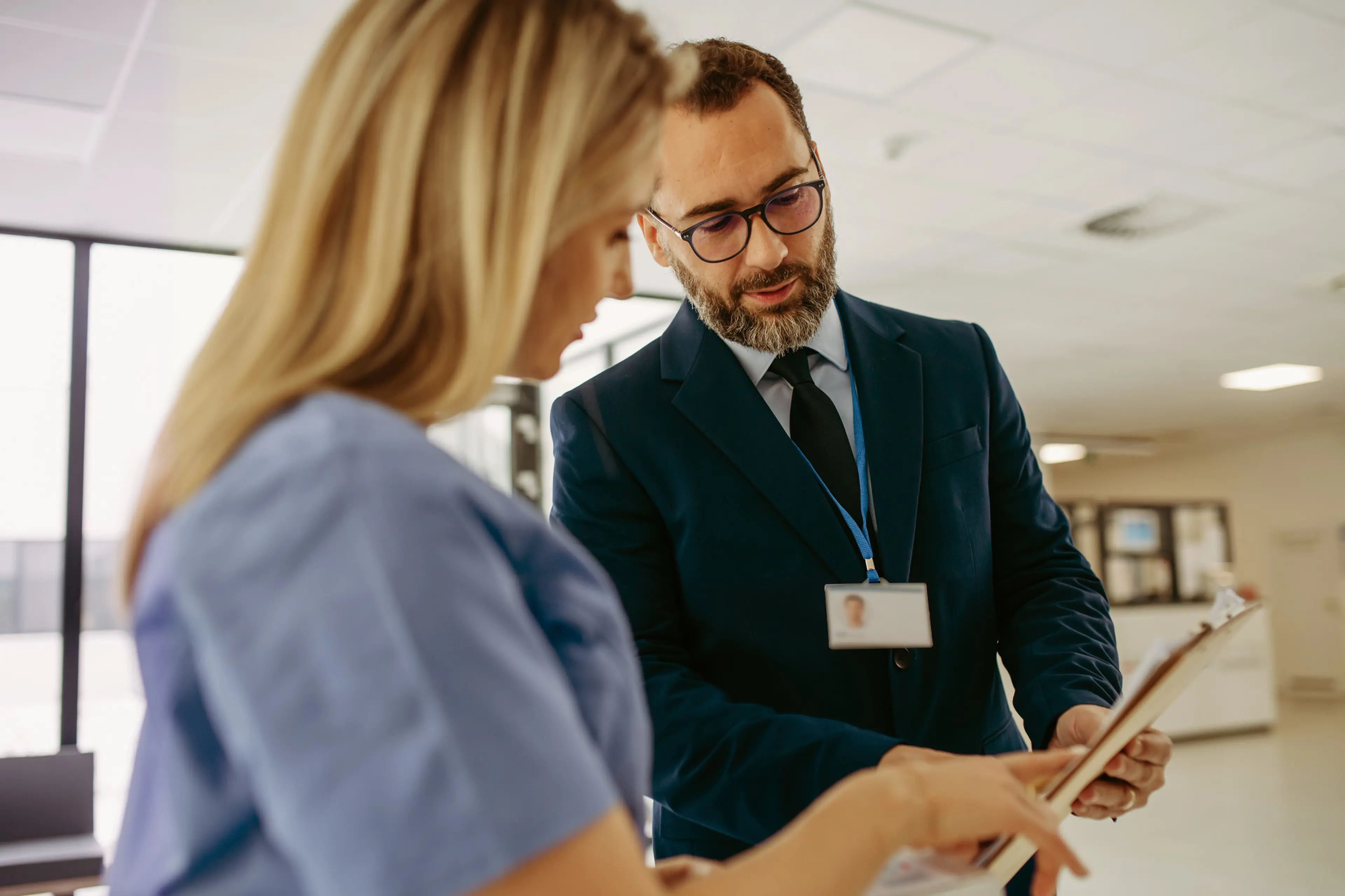 GP talking to healthcare professional staff whilst looking at paperwork